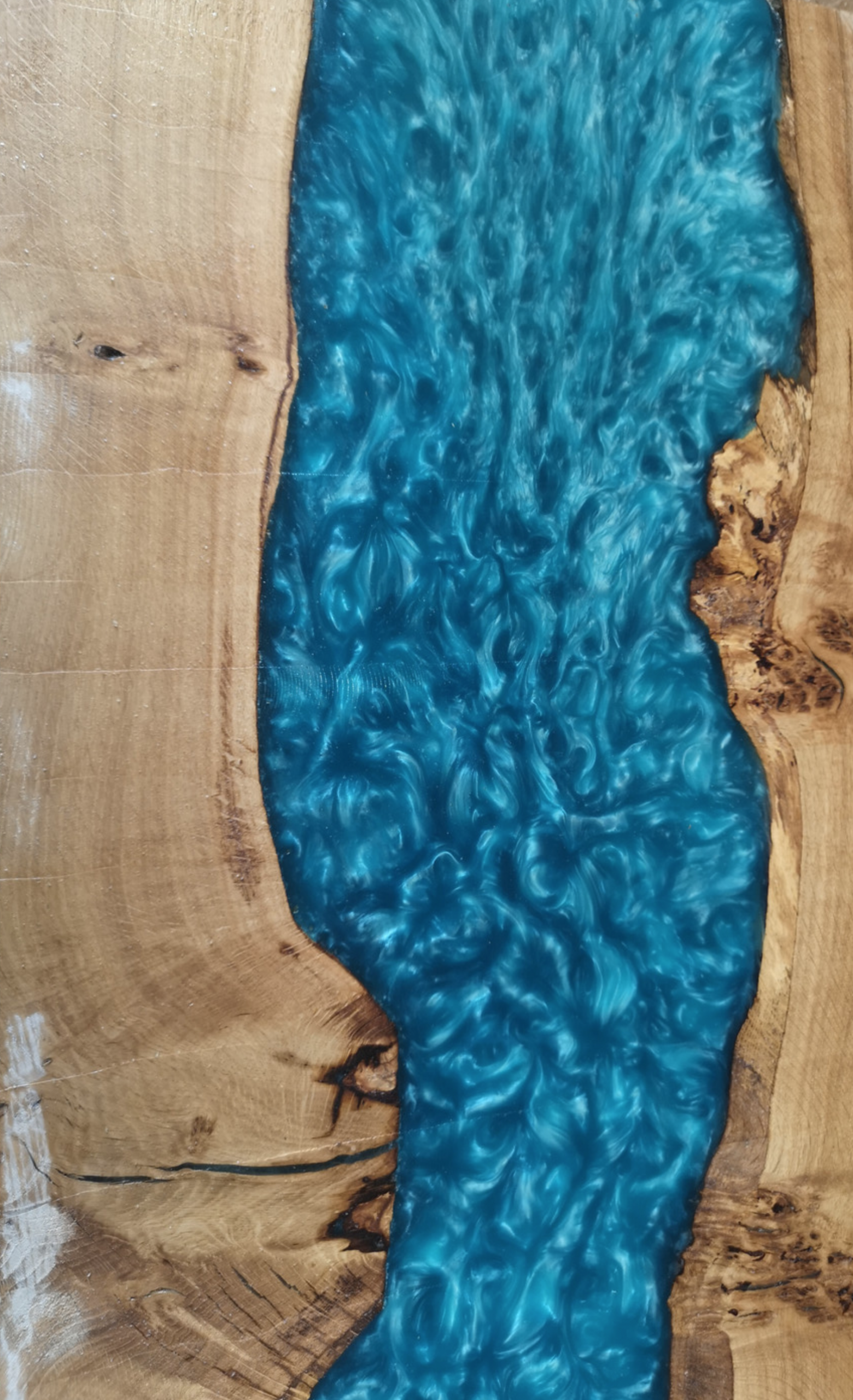 a wood and blue resin river table